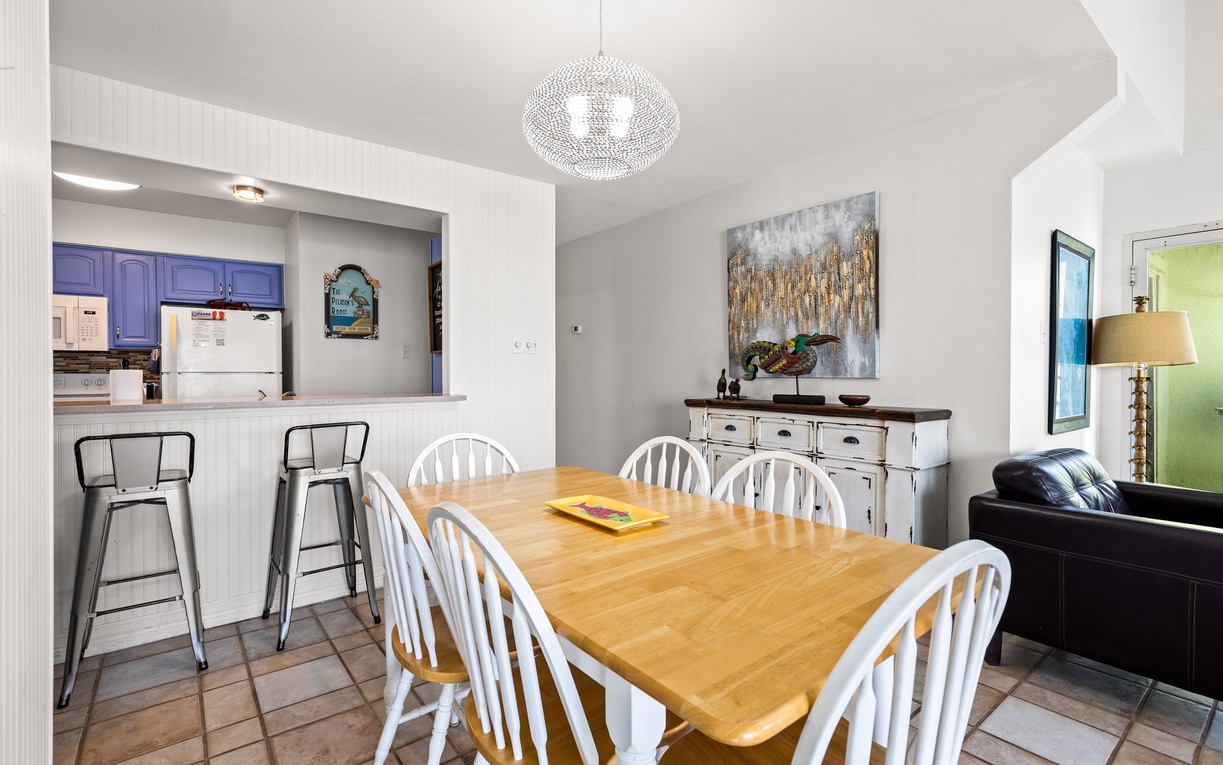 Gather around your spacious dining table where shared meals become cherished memories under elegant pendant lighting.
