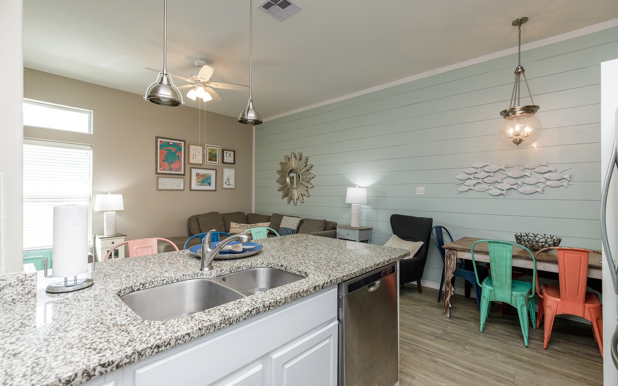 Gather around your open-concept kitchen and dining space, where granite counters and colorful seating create the perfect backdrop for memorable meals together.