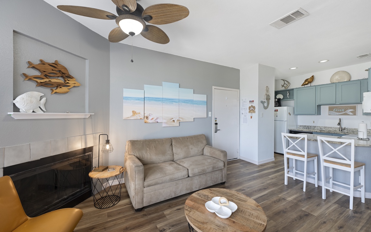 Kick back in your beachy living space, where calming coastal tones, plush seating, and a soft ceiling fan breeze set the tone for total relaxation.