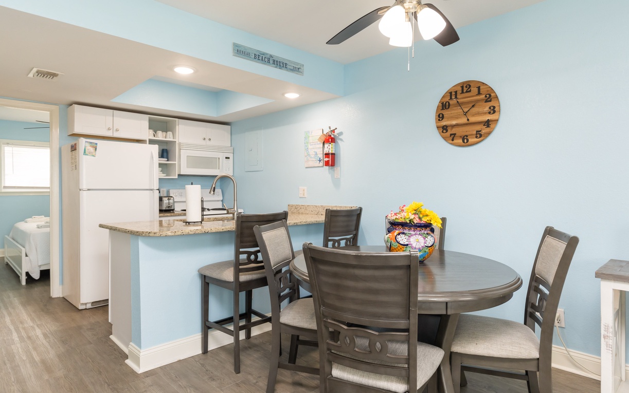 Gather around your spacious dining table while the ceiling fan keeps you comfortable and the open kitchen makes meal prep effortless.