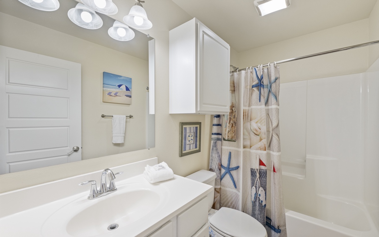 Refresh in your coastal-themed bathroom with modern fixtures, nautical decor, and bright lighting for your perfect morning routine.