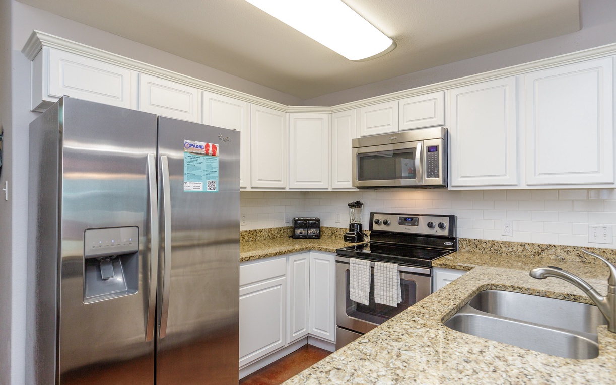 Your fully equipped kitchen awaits with granite countertops, stainless steel appliances, and all the modern conveniences for cooking memorable meals.