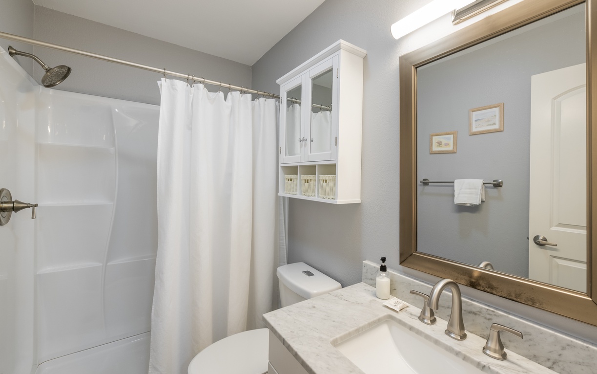 Step into your second floor guest bathroom sanctuary with marble countertops, spacious shower, and thoughtful storage for your comfort.