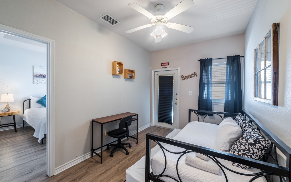 Step into your bright, airy living space where coastal charm meets modern comfort, complete with a ceiling fan to keep you cool.