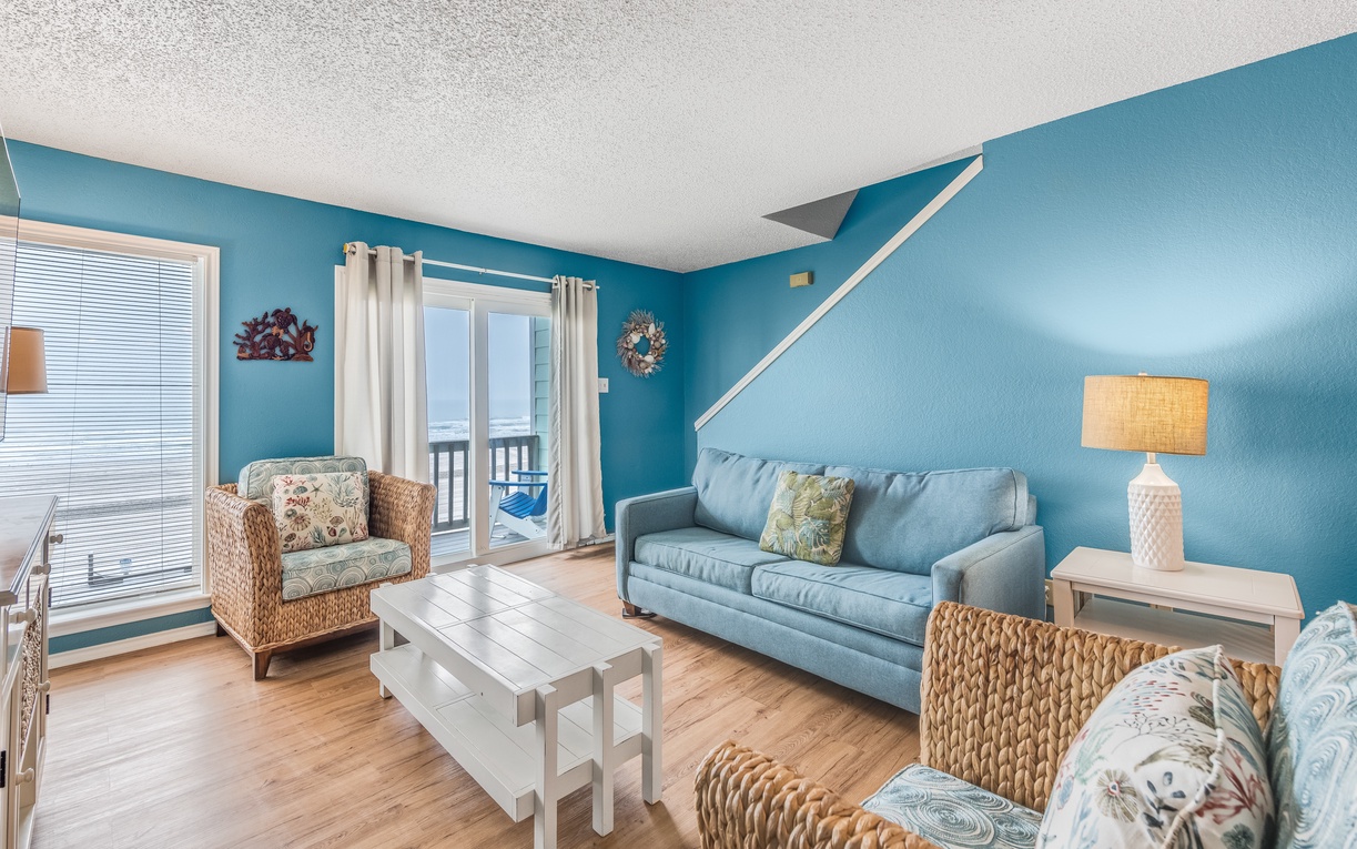 Your bright coastal living room features comfortable seating and a queen size sleeper sofa