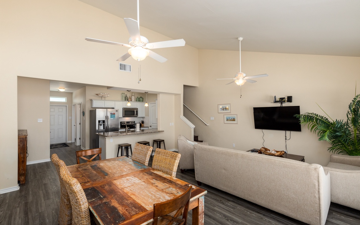 Relax in your open-concept living space with rustic dining, modern kitchen, and cozy seating area for memorable vacation moments.