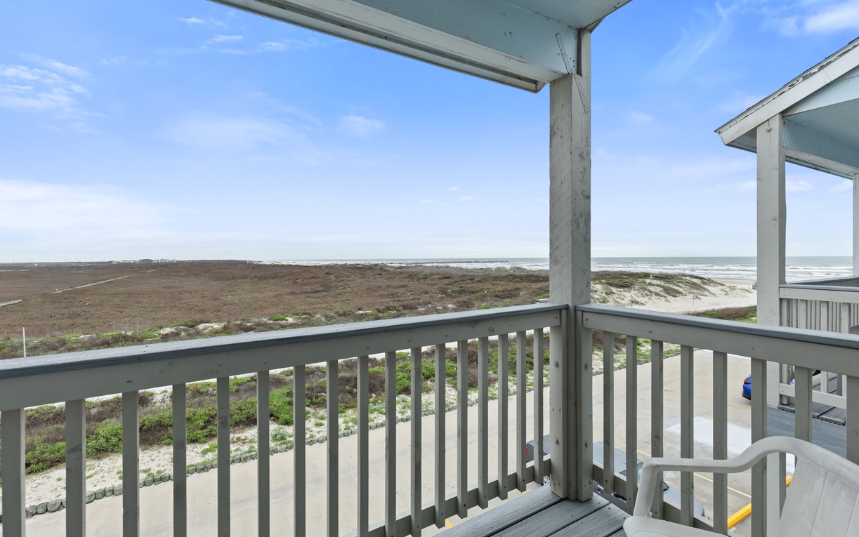 Covered balcony with peaceful ocean and dune views for morning coffee moments.