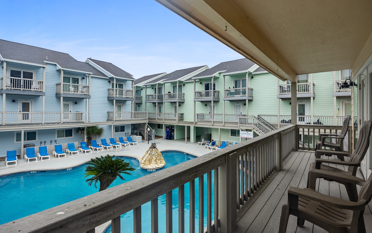 Step onto your private balcony and soak in stunning pool views while colorful beach buildings create a charming coastal backdrop for your getaway.