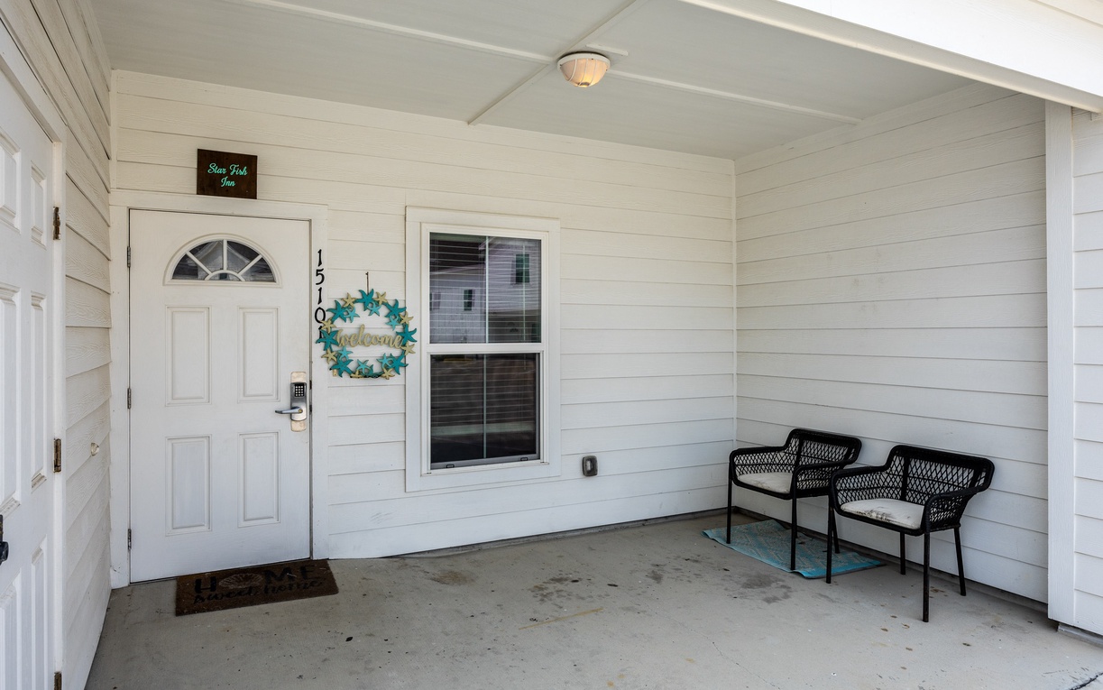 Your welcoming covered porch offers a peaceful spot to unwind with comfortable seating and charming coastal-inspired touches.