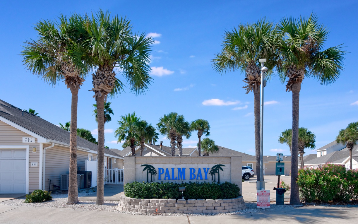 Palm Bay property entrance welcomes visitors with tropical landscaping and clear signage marking arrival at this coastal destination.
