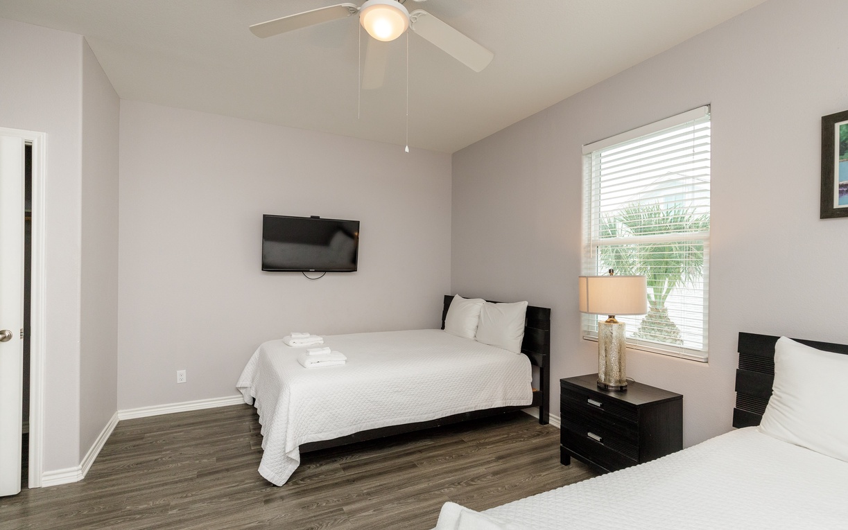 Relax in your serene twin bedroom with crisp white linens, modern amenities, and peaceful natural light streaming through the window.