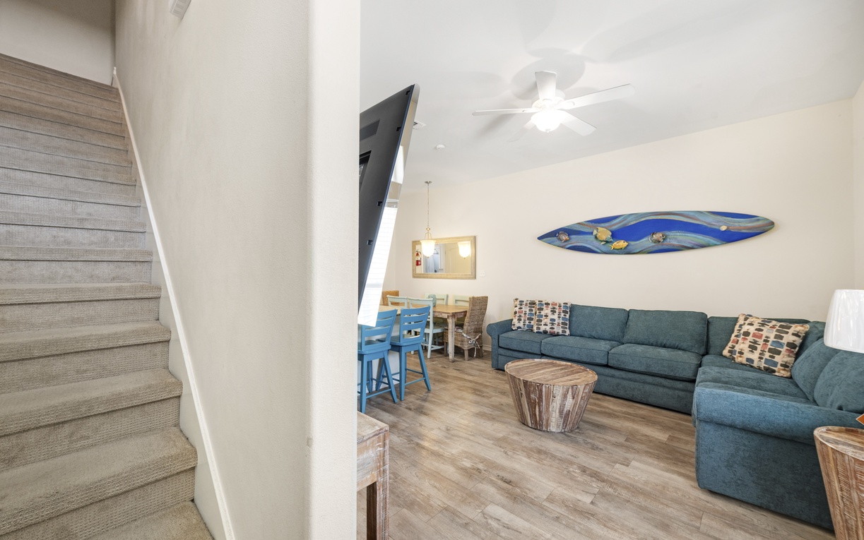 Relax in your spacious living area with comfortable seating and coastal touches, perfect for unwinding after beach adventures.