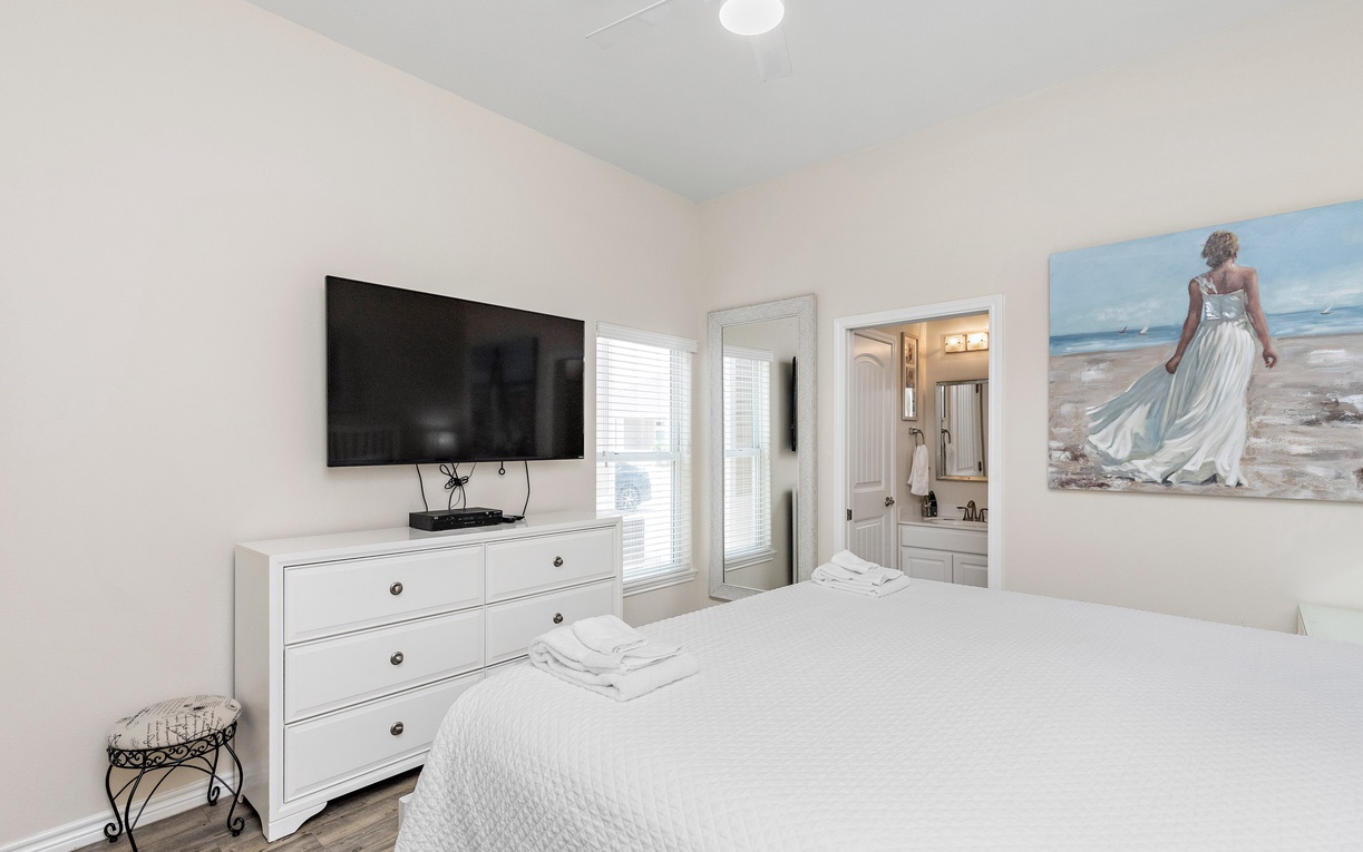Relax in your bright bedroom with crisp linens, flatscreen TV, and private ensuite bathroom for ultimate comfort.