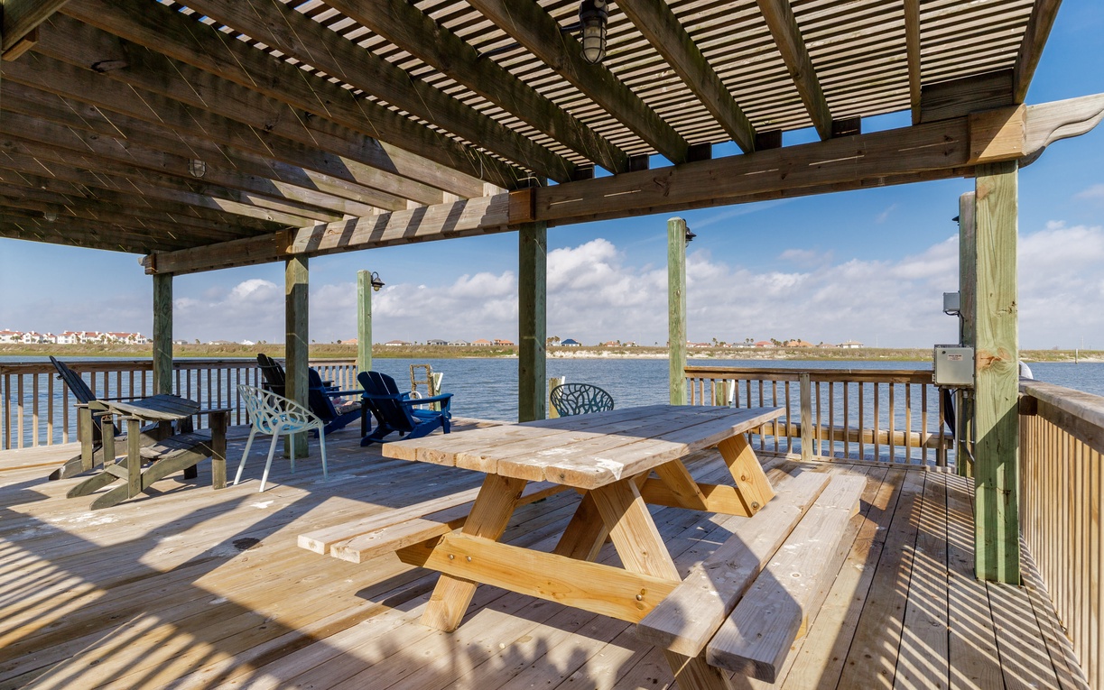 Your private waterfront deck awaits with picnic table and lounge chairs, offering stunning lake views for peaceful mornings and sunset gatherings.
