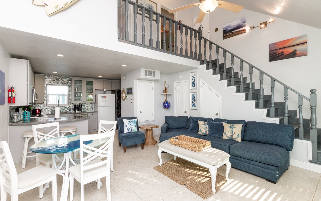 Relax in this bright open-concept space where coastal charm meets comfort. Your living room flows seamlessly into the kitchen, perfect for vacation gatherings.