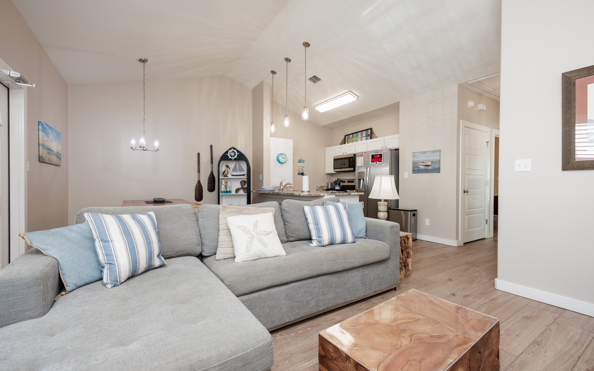 Relax in this bright, coastal-themed living space where soft blues and nautical touches create your perfect beachside retreat.
