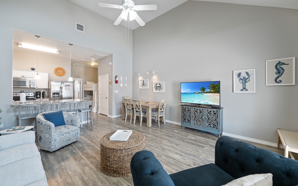 Settle into your coastal-themed living space where ocean-inspired artwork and nautical decor create the perfect backdrop for relaxing evenings.