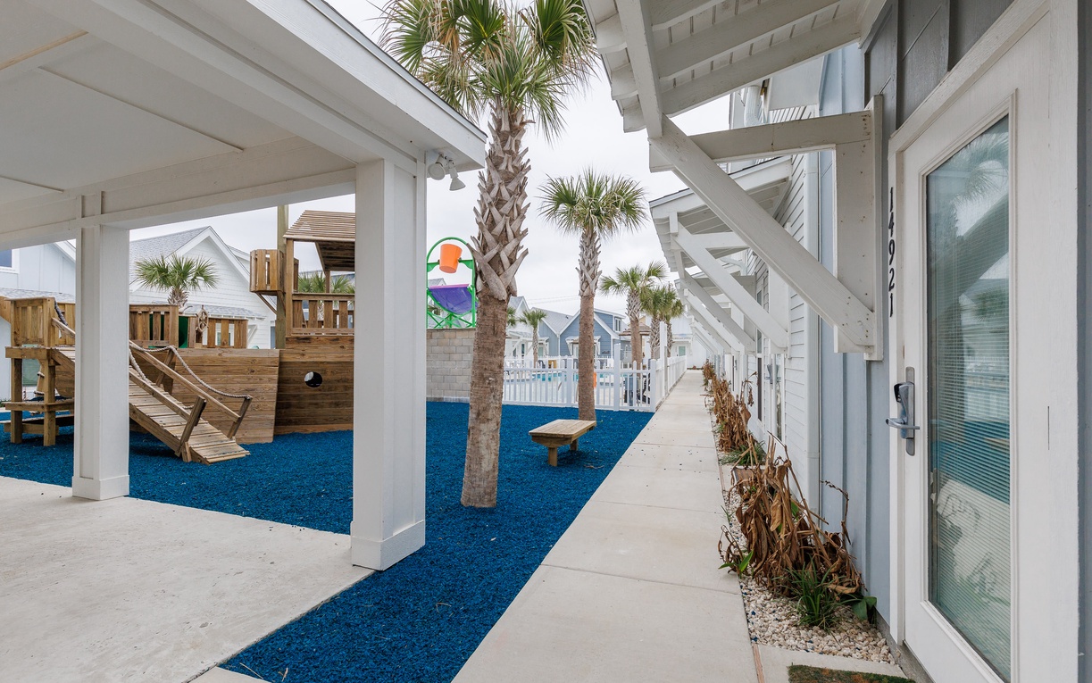 Step onto your private walkway leading to a vibrant playground where palm trees sway and coastal adventures begin.