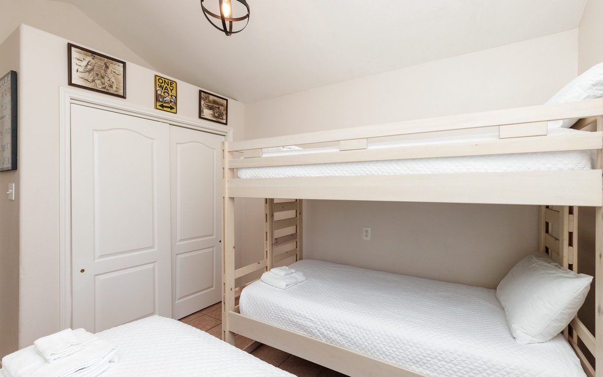 Your family room features a cheerful bunk bed and twin bed, perfect for kids' adventures and cozy nights together.
