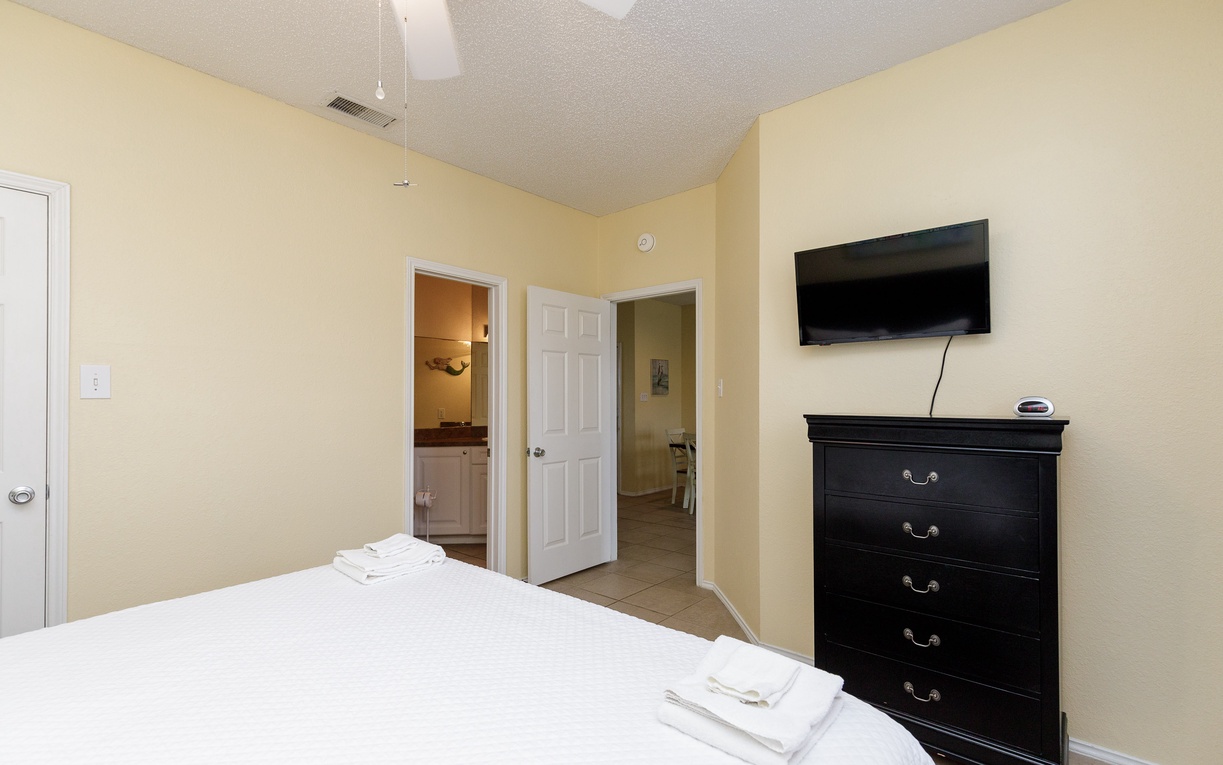 Unwind in your comfortable bedroom with plush towels, entertainment center, and convenient access to your private en-suite bathroom.