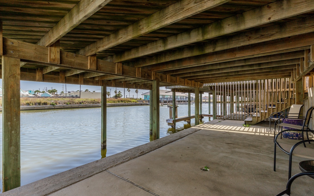 Relax in your private waterfront haven with shaded seating overlooking tranquil canal waters—perfect for morning coffee or evening reflection.
