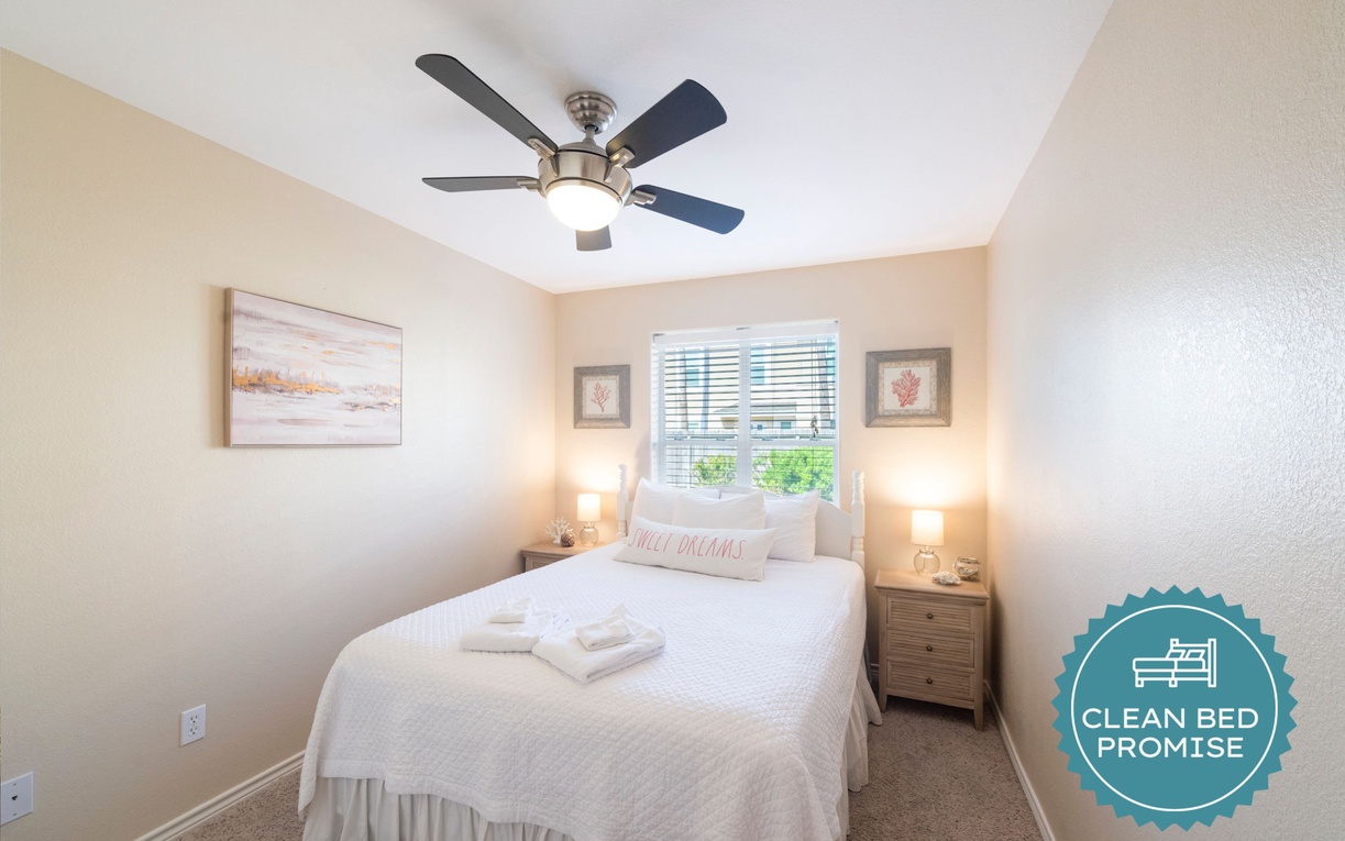 Drift off to sleep in your cozy bedroom with crisp linens, gentle ceiling fan breeze, and soft bedside lighting creating perfect comfort.