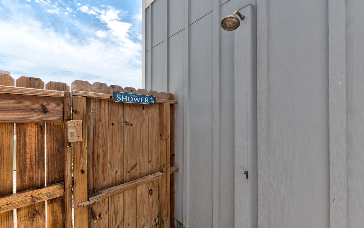 Outdoor shower off the patio space for extra convenience rinsing off after the beach.
