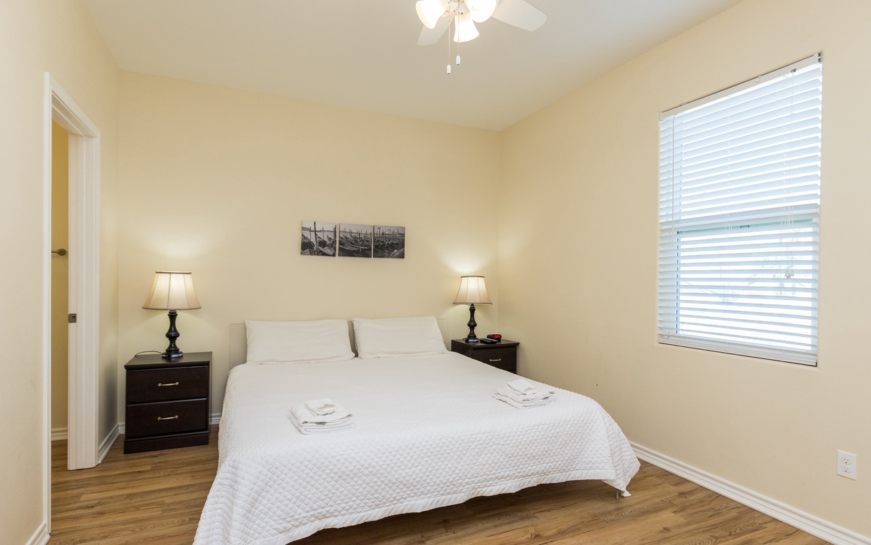 Unwind in your serene bedroom with fresh linens and warm lighting creating the perfect retreat.