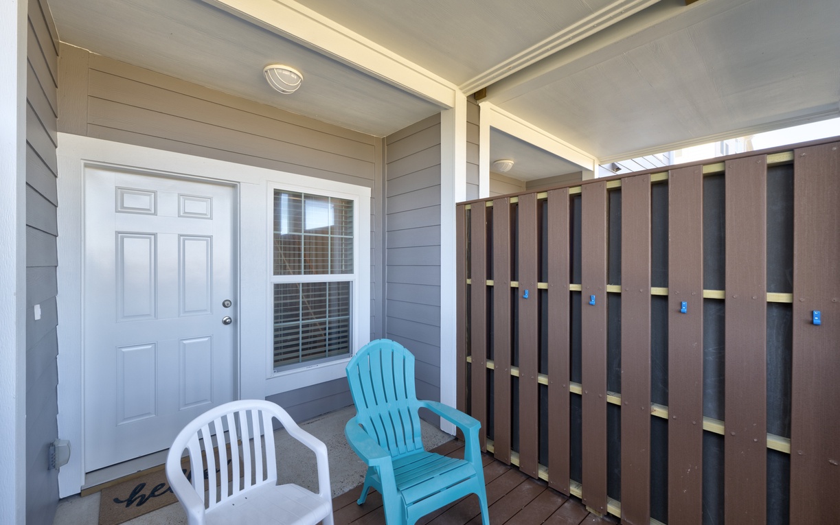 Step onto your private covered patio and settle into colorful chairs for morning coffee or evening relaxation.