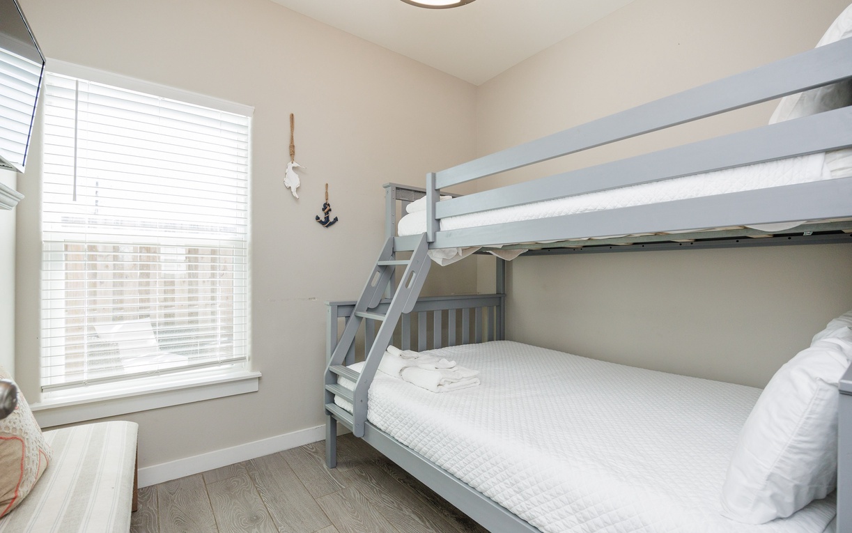 Three more guests will enjoy sleeping in this bunk room that features a twin over full bunk bed and TV for entertainment.