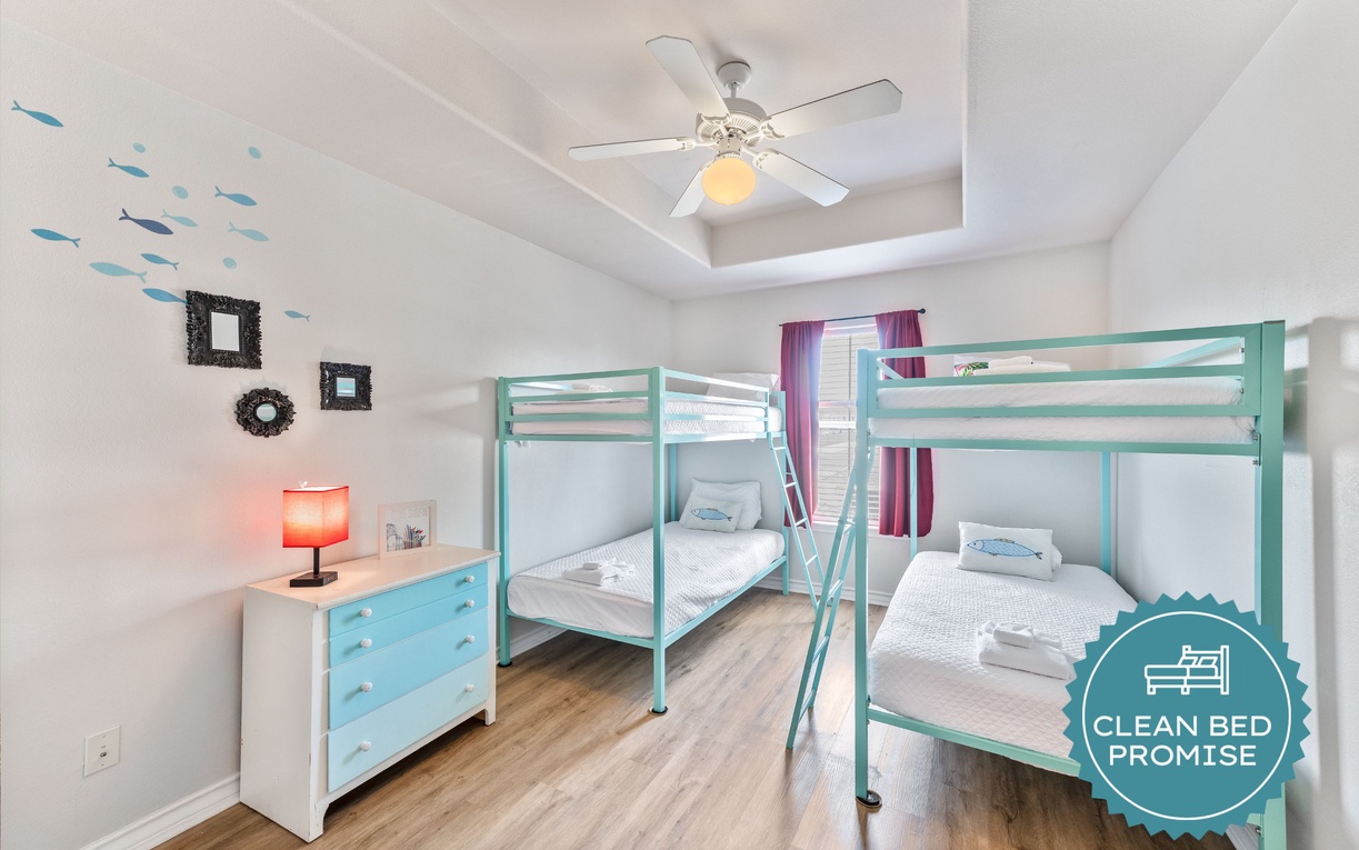 Your kids will love this ocean-themed bunk room with playful fish wall decals and cozy beds ready for sweet dreams.