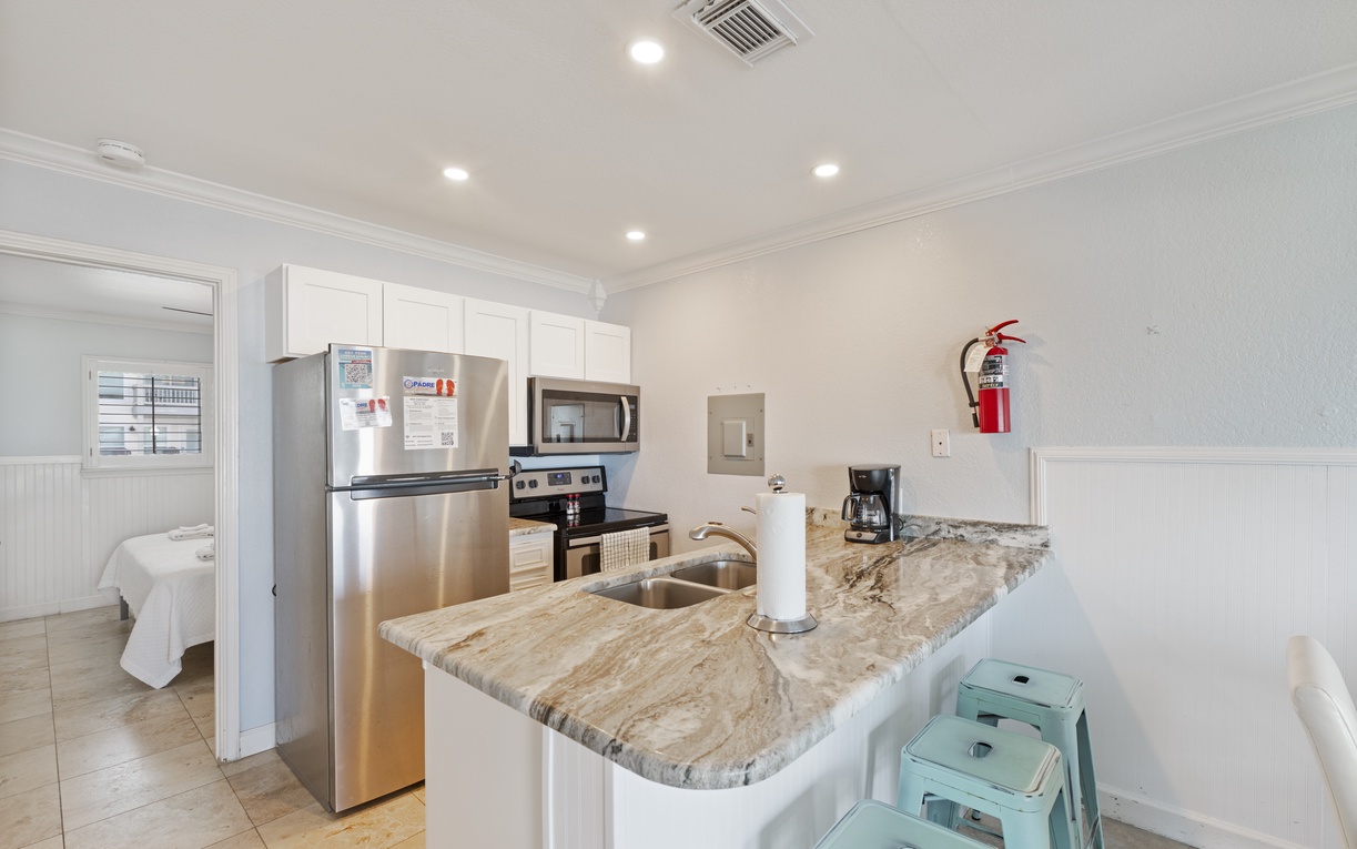 Your fully equipped kitchen awaits with granite counters, stainless appliances, and everything you need to create memorable meals during your stay.