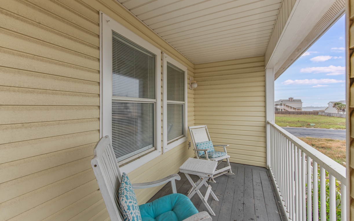 Settle into your private covered porch with comfy seating and watch the world go by from this peaceful retreat.