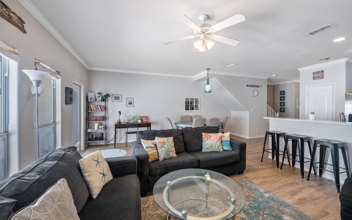 Relax in your spacious living room featuring comfortable seating, modern decor, and an open layout perfect for gathering with loved ones.