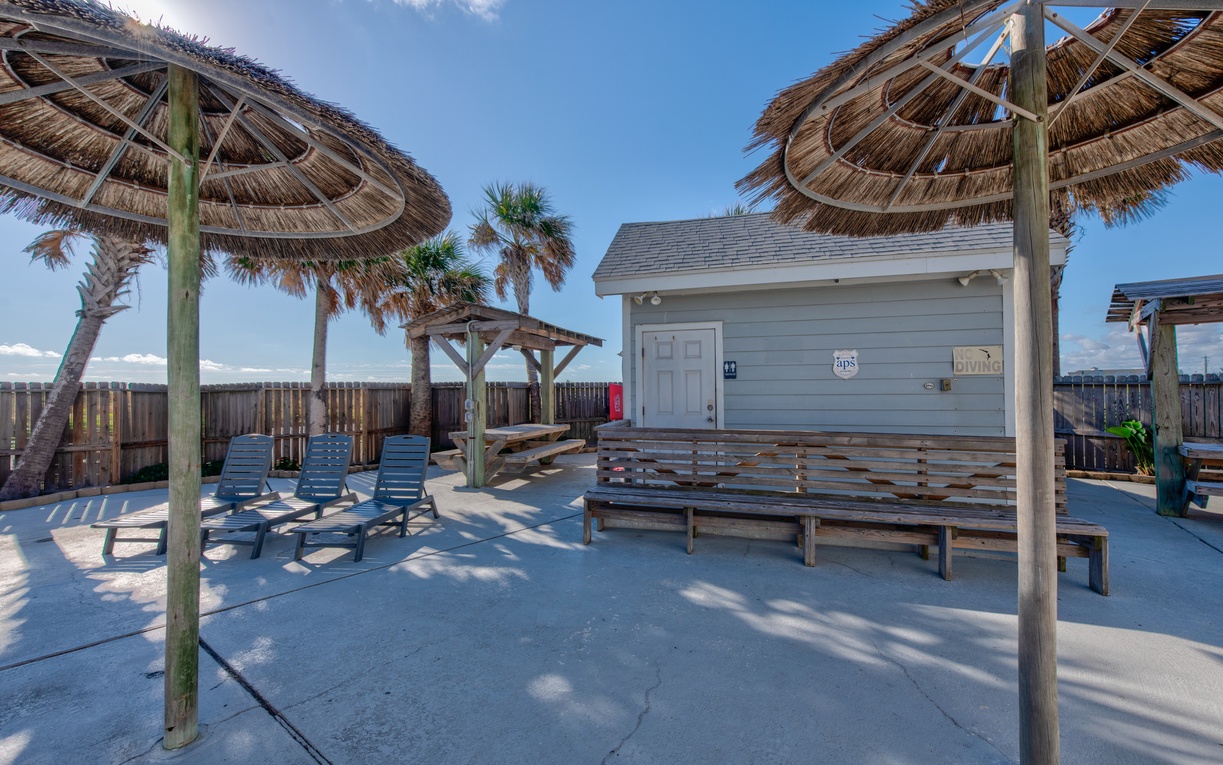 Relax under tropical thatched umbrellas in your private outdoor oasis, where sunny afternoons and coastal breezes create the perfect beach retreat.