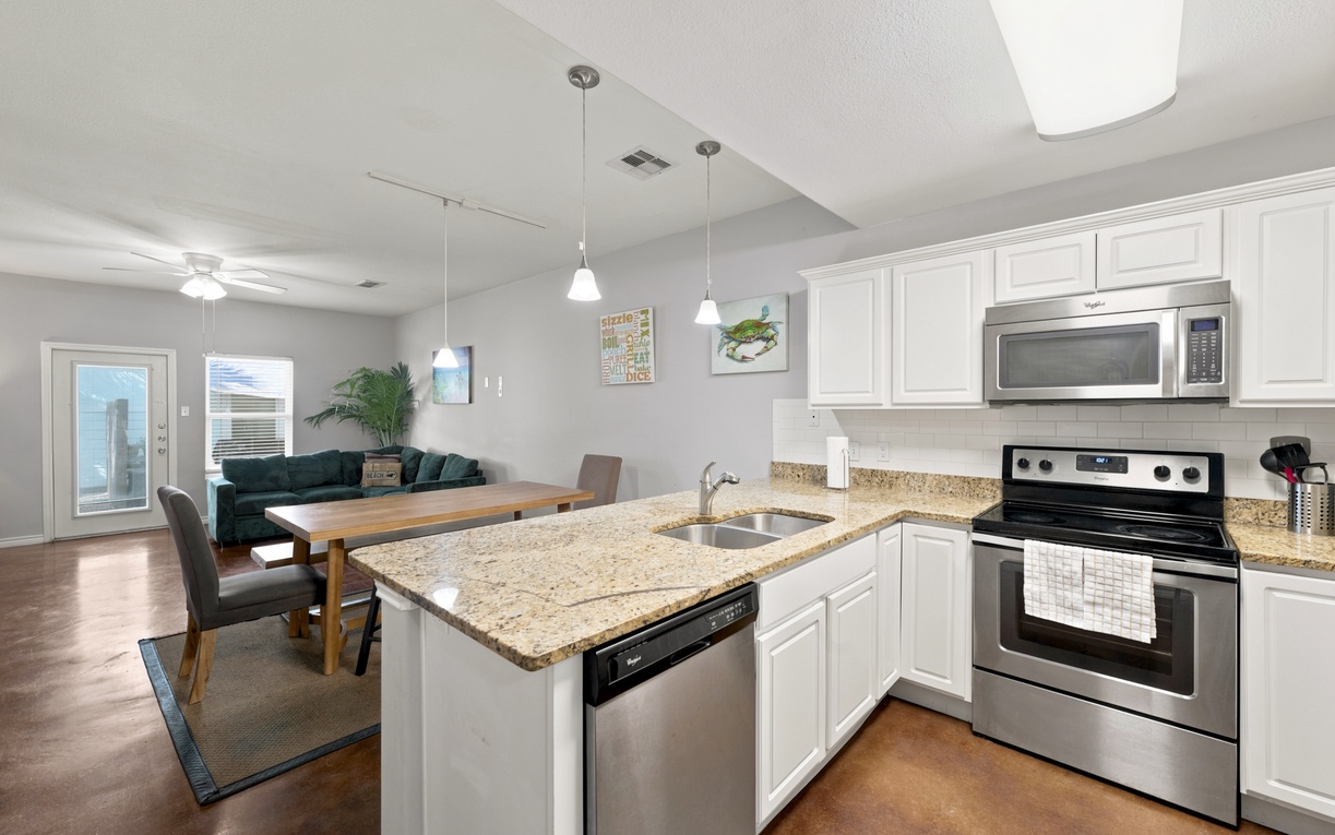 Your open-concept kitchen flows seamlessly into the dining and living areas, complete with granite countertops, stainless appliances, and everything you need to prepare meals and gather with loved ones.