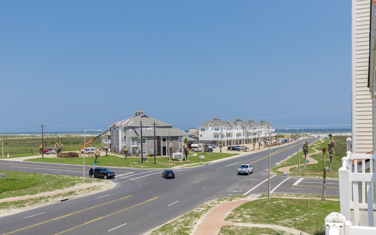 Coastal road leads to beachfront properties with ocean access nearby.