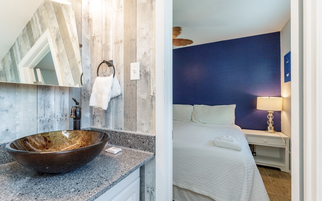 Guest bathroom offering a stylish look with vessel sink and tub/shower combo.