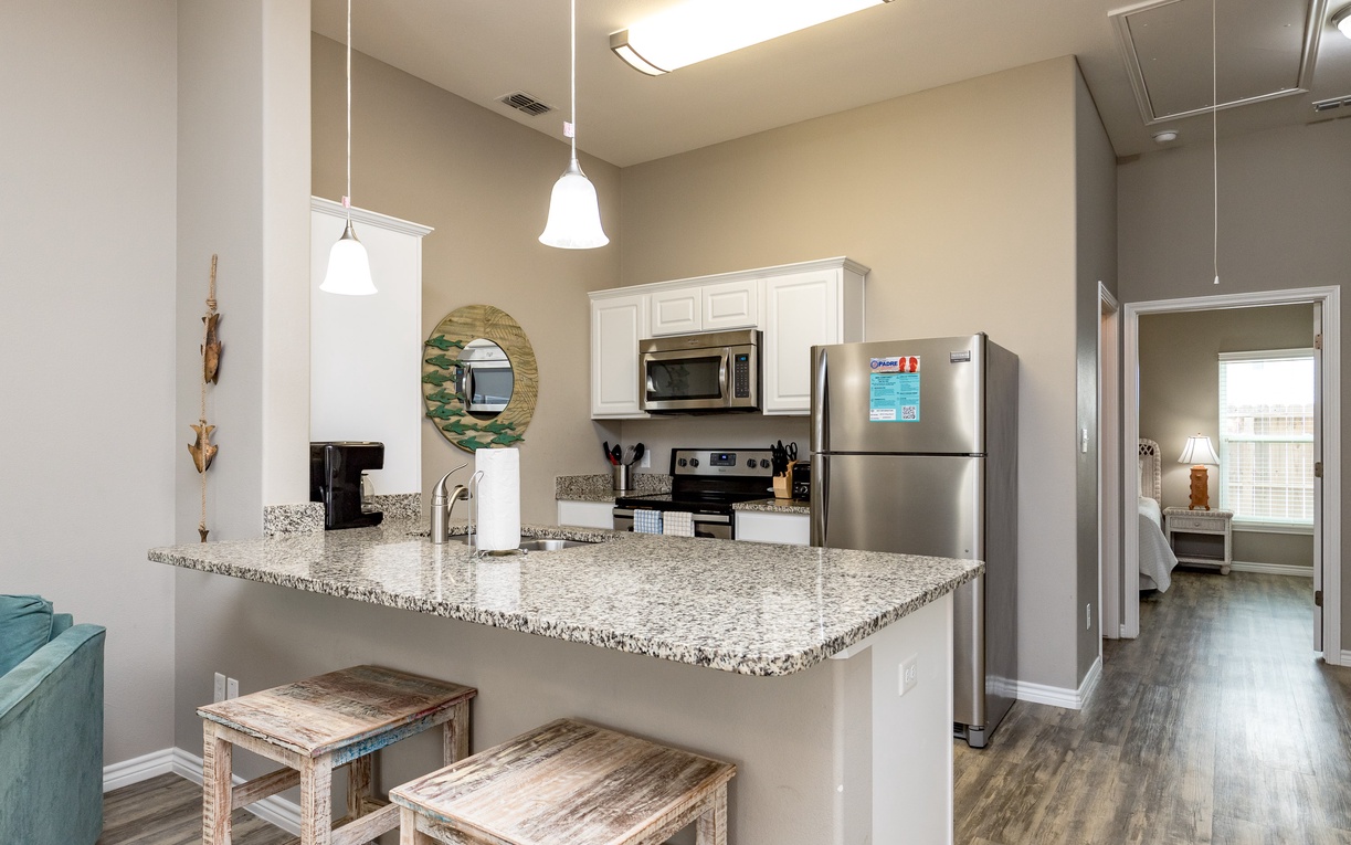 Your spacious kitchen features granite countertops, stainless steel appliances, and a breakfast bar where you can enjoy morning coffee.
