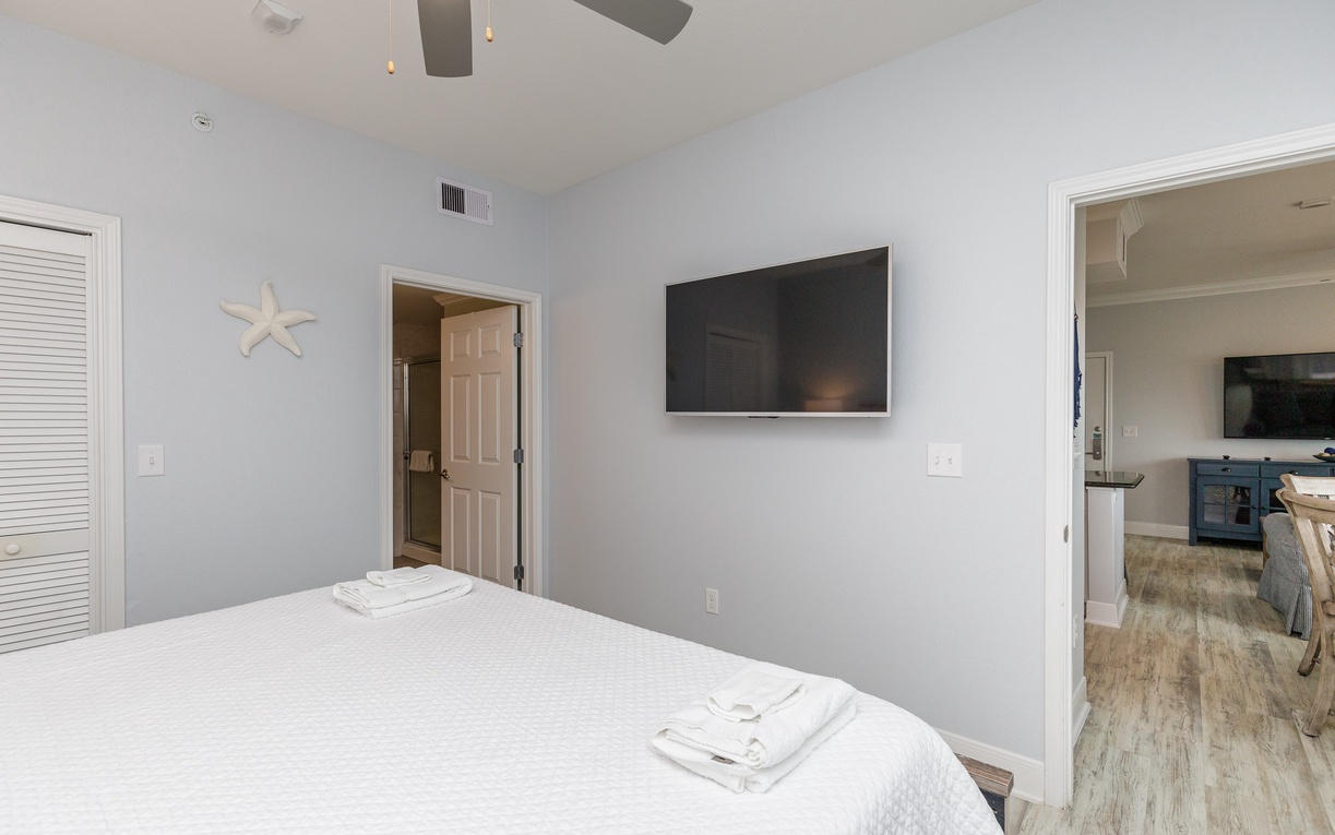 Primary bedroom with king size bed and ensuite bathroom