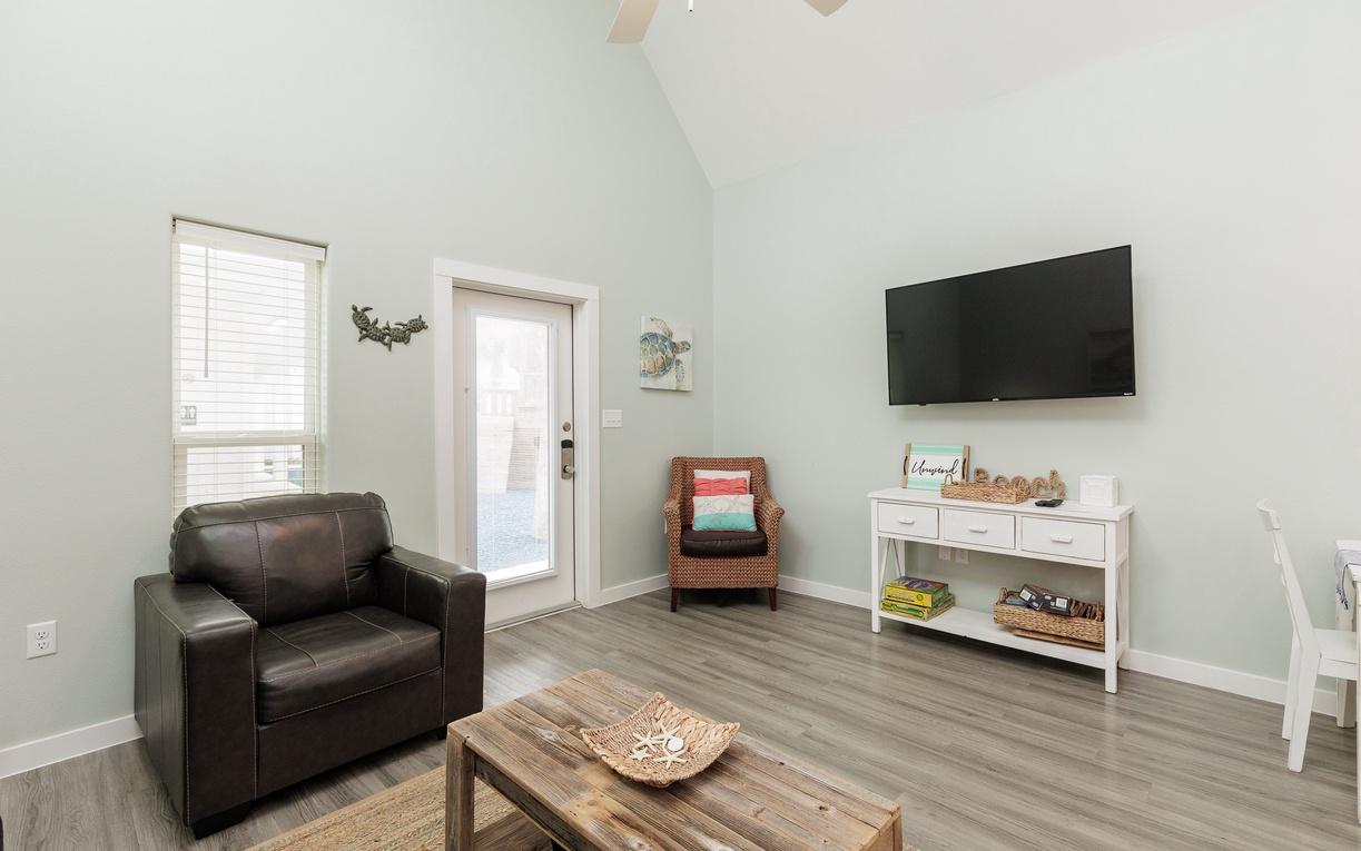 Relax in your bright living space with comfy leather seating, flat-screen TV, and charming rustic touches throughout.