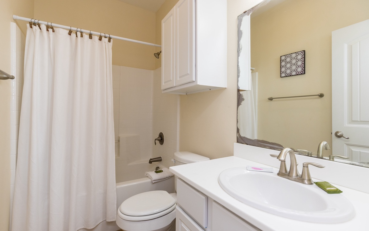 Step into your spotless bathroom featuring a relaxing tub-shower combo, fresh towels, and everything you need for a refreshing start to your day.