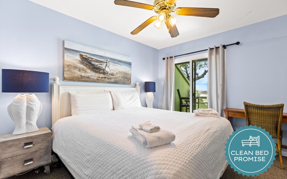 Your serene bedroom sanctuary features coastal decor and opens to your private balcony with beautiful views.