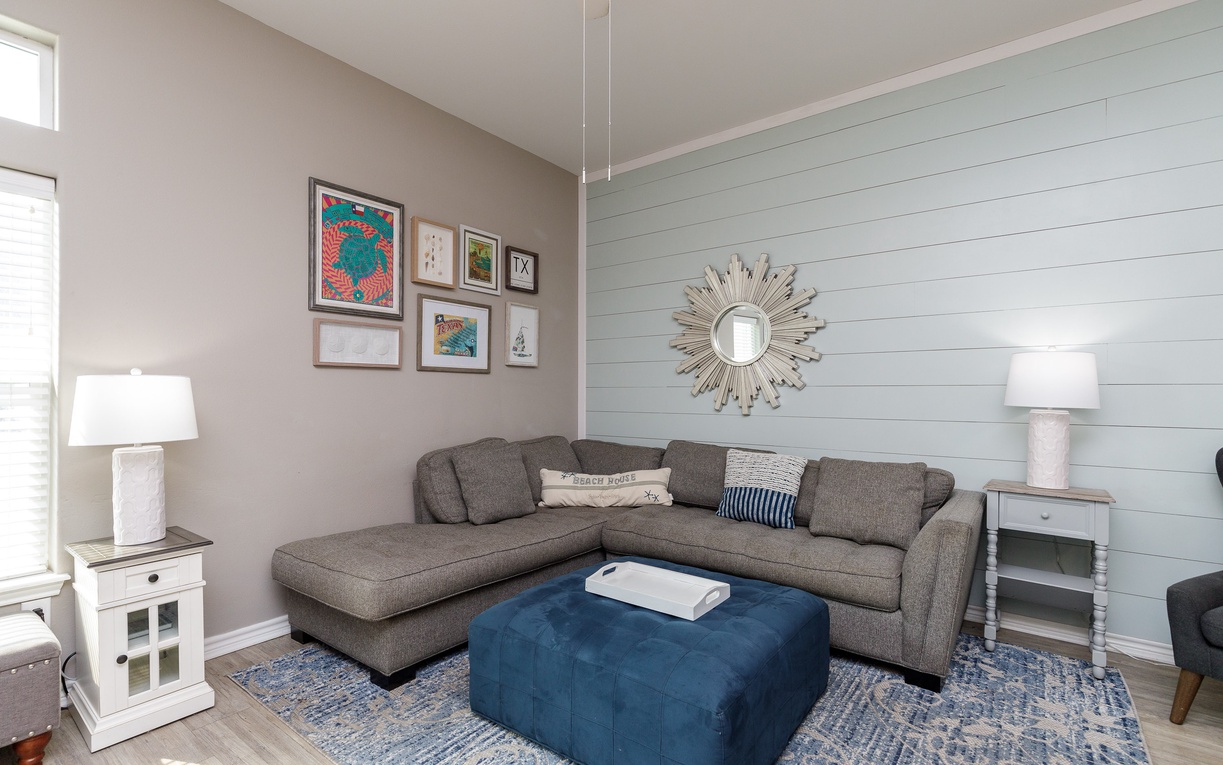 Sink into coastal comfort in this inviting living room, where shiplap walls and nautical touches create your perfect beach house retreat.