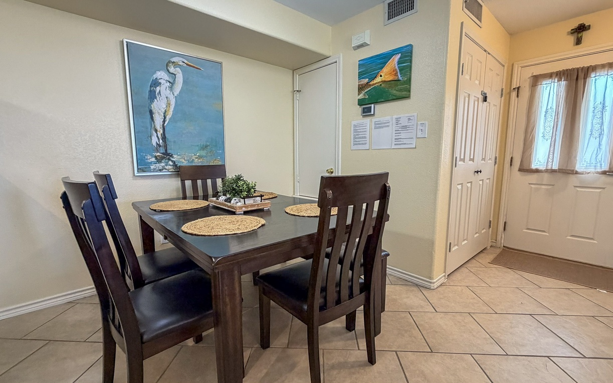Your cozy dining space welcomes you with warm natural light and thoughtful coastal touches, perfect for sharing meals together.