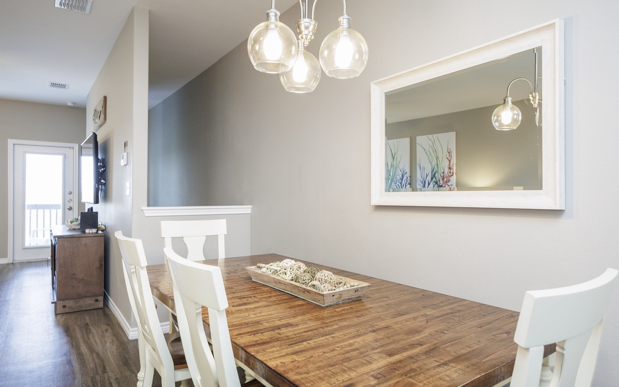 Gather around this beautiful rustic dining table where warm lighting creates the perfect atmosphere for memorable meals together.