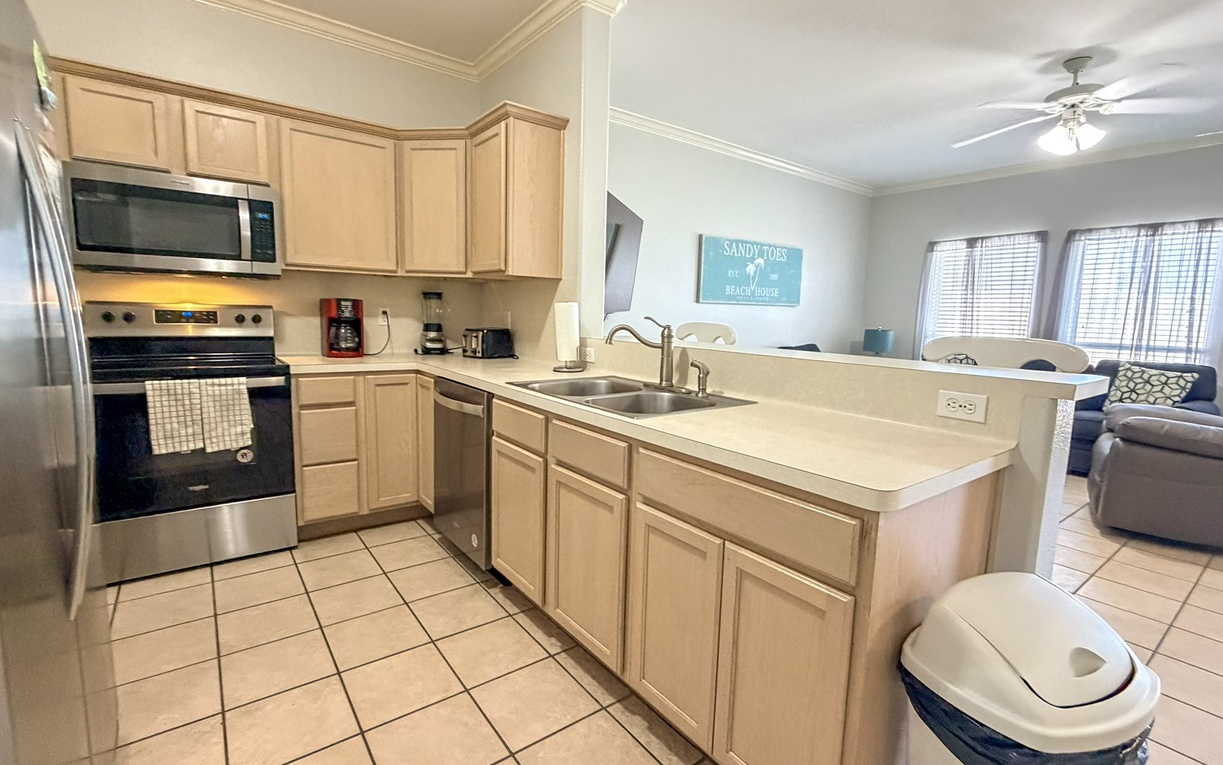 Your fully equipped kitchen features modern appliances and ample counter space for preparing meals during your beach getaway.