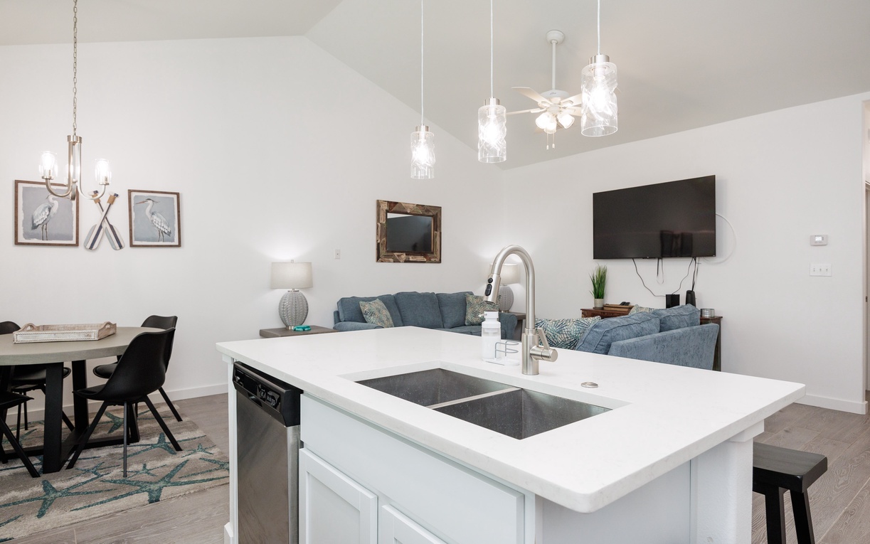 Your modern kitchen island flows seamlessly into the stylish living space, perfect for cooking while staying connected with family.