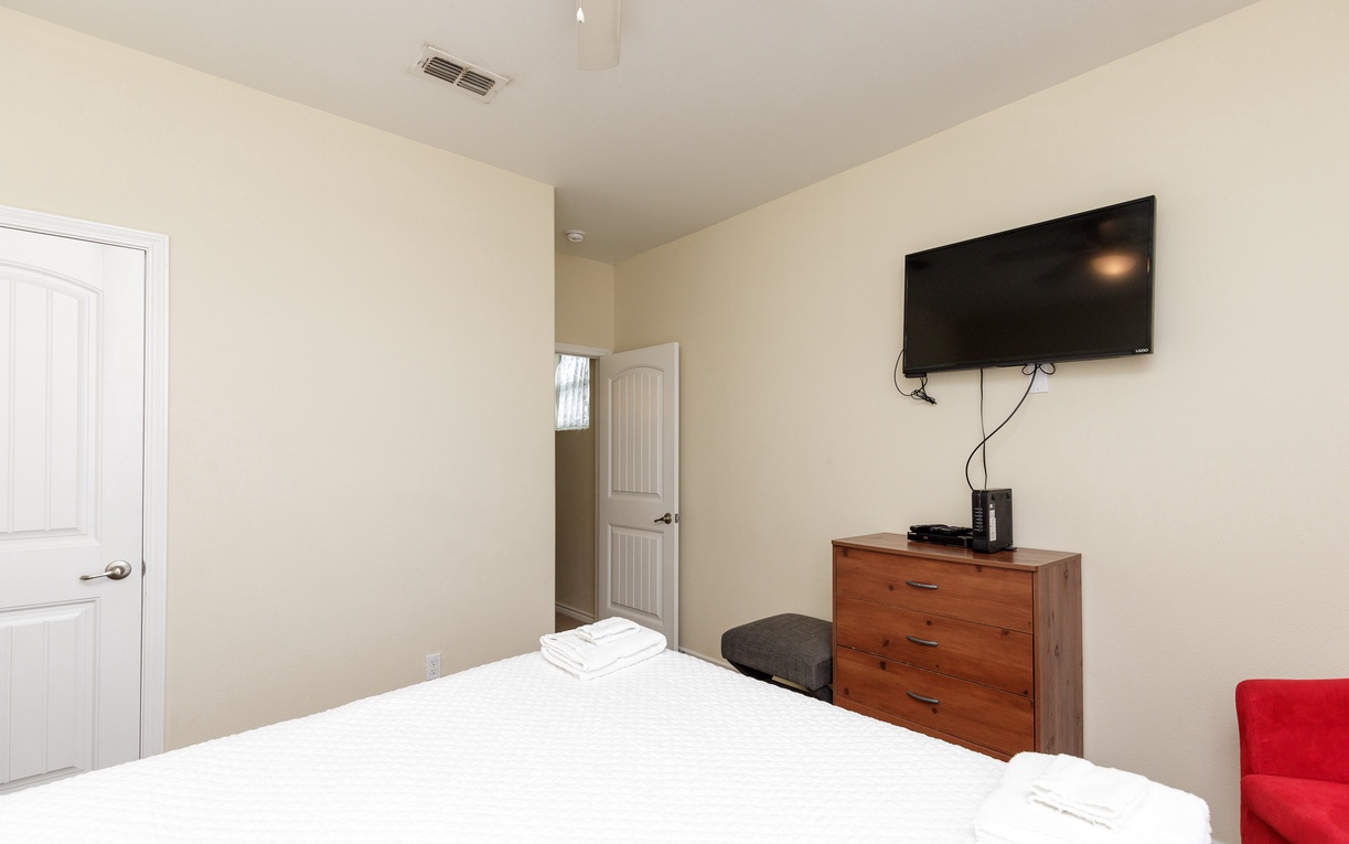 Relax in your comfortable bedroom with fresh linens, modern TV, and thoughtful touches for a restful stay.