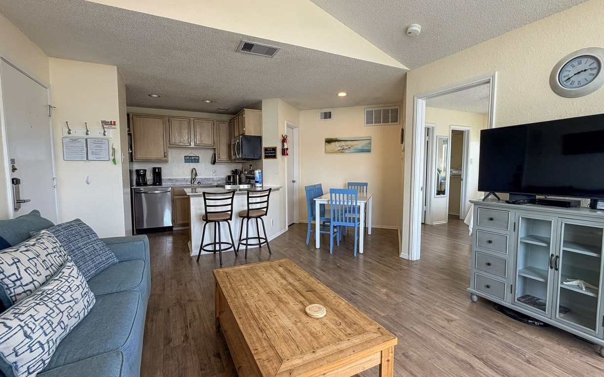 Relax in your bright open-concept space where the living room flows into a fully equipped kitchen, perfect for unwinding after beach days.
